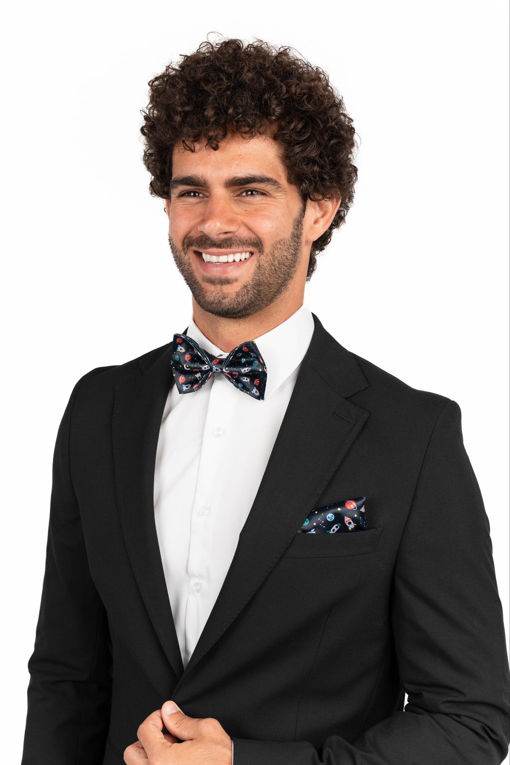 Man wearing a black suit with a floral bow tie and pocket square on a white background