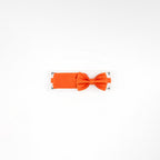 Orange bow tie on a white background