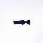 Navy blue bow tie on a white background